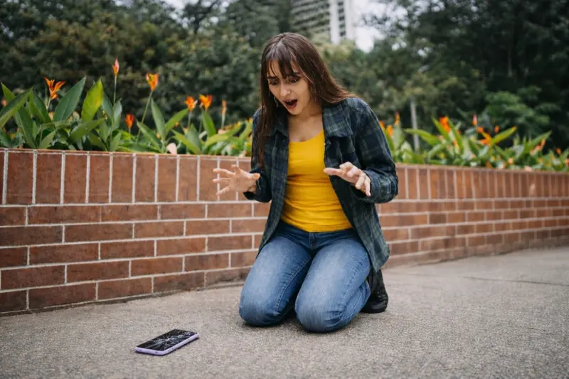 Broken phone on sidewalk